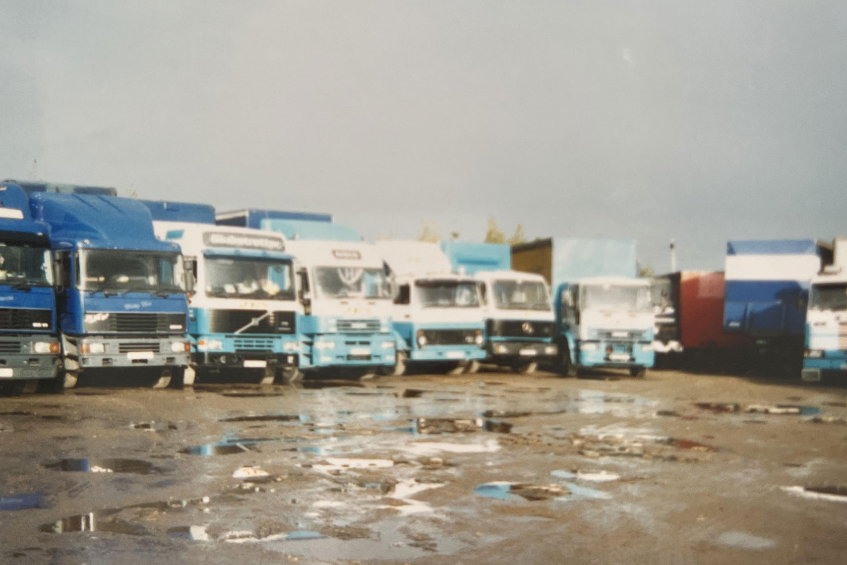 Old image of the new location with all of the trucks we had at the time, all blue and white trucks in the yard.