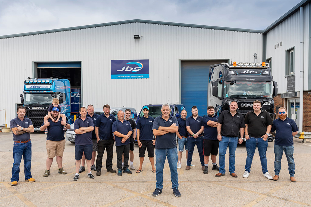 Image of the JBS Haulage & Workshop team outside the workshop lined up for the photo.